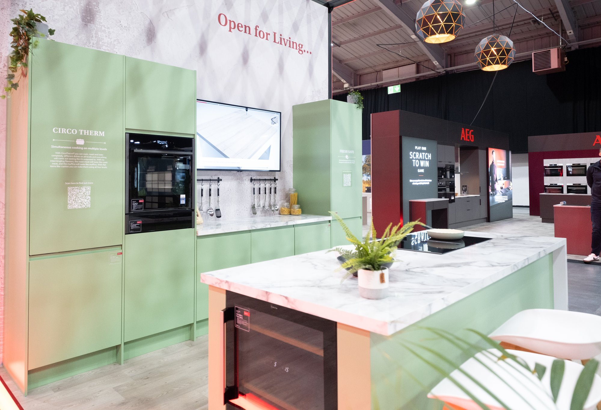 Shot of a green kitchen at the NEFF Kitchen Display Exhibition Stand,