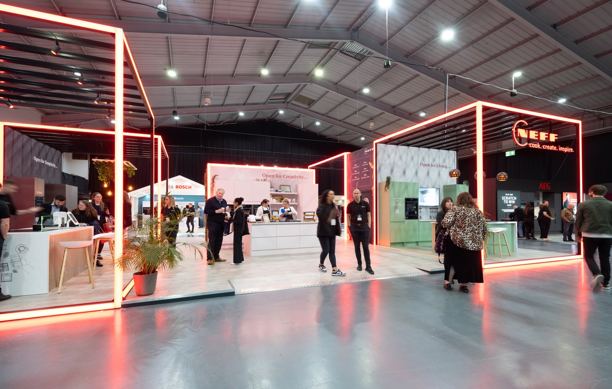 Wide shot of the NEFF Kitchen Display Exhibition Stand with people interacting.