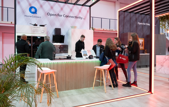 Shot of people interacting at the NEFF Kitchen Display Exhibition Stand.