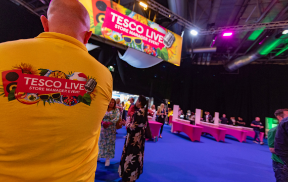 Shot of someone in a yellow Tesco Live tshirt